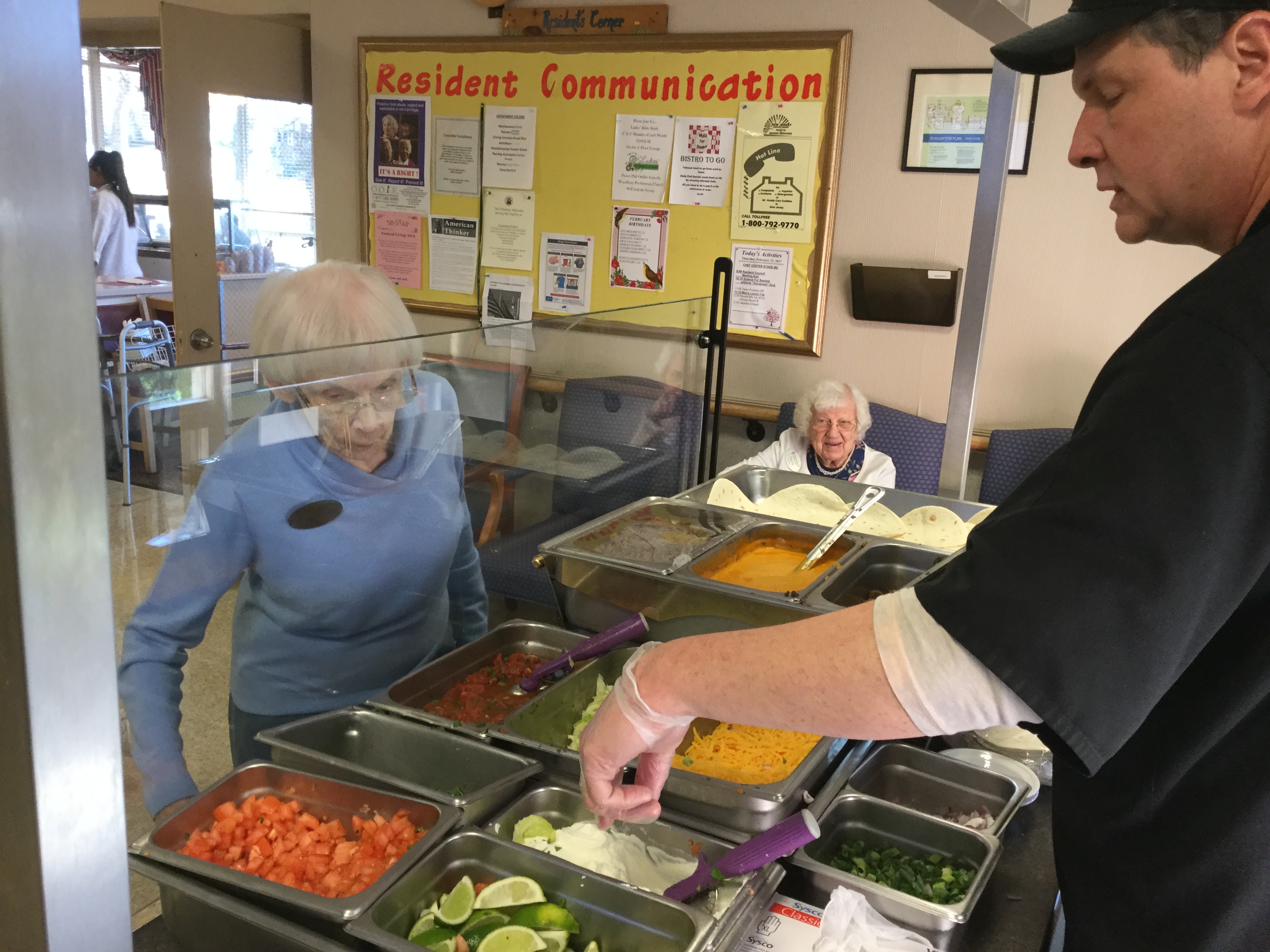 a group of people in a room with food on the table